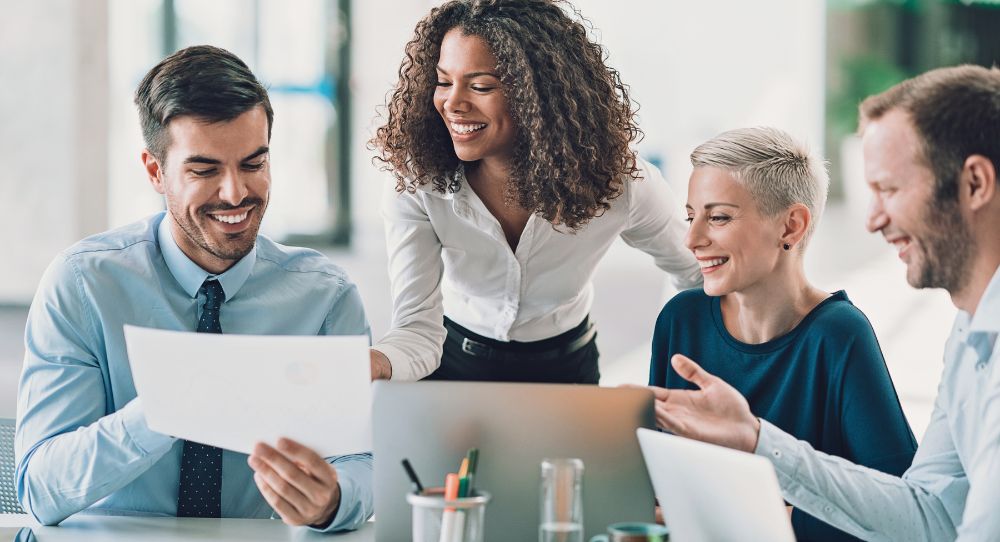 board executives smiling over a computer